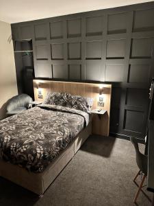 a bedroom with a large bed with a large headboard at The Welshman’s Arms in Pembrokeshire