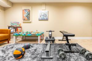 a living room with a gym with a ping pong table at Beautiful & Large Townhouse in Downtown Arlington Near DC in Arlington