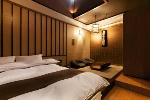 Postel nebo postele na pokoji v ubytování HOTEL GEN 福知山店 + 1 fotografie
