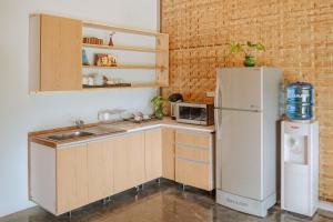 a kitchen with a refrigerator and a sink at Society House Luxury Hostel in Pai