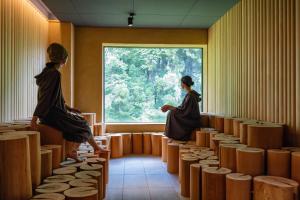 two women in a room looking out a window at Urari Takeo Garden Terrace Spa Resorts in Takeo