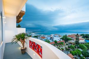 a balcony with a view of a city at Happiness Hotel in Quy Nhon