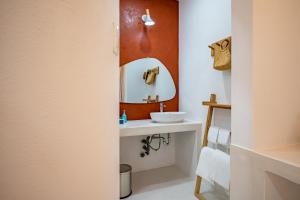 a bathroom with a sink and a mirror at Happiness Hotel in Quy Nhon