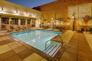 a pool in a hotel with chairs and tables at Residence Inn by Marriott San Diego Downtown/Gaslamp Quarter in San Diego