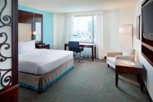 a hotel room with a bed and a desk and a chair at Residence Inn by Marriott San Diego Downtown/Gaslamp Quarter in San Diego