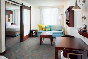 a hotel room with a couch and a bed at Residence Inn by Marriott San Diego Downtown/Gaslamp Quarter in San Diego