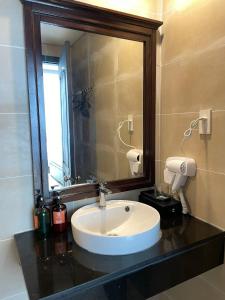 ein Badezimmer mit Waschbecken und großem Spiegel in der Unterkunft Welcome You to Vung Tau 2 bedroon with Nice Sea View in Vũng Tàu