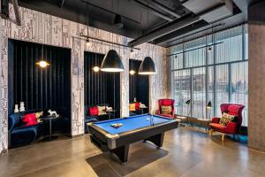 a billiard room with a pool table and chairs at Aloft Anchorage in Anchorage