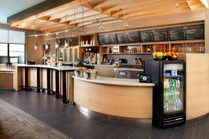 a large kitchen with a bar in a restaurant at Courtyard by Marriott Akron Downtown in Akron