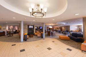 a lobby of a hotel with couches and tables at Courtyard by Marriott Canton in North Canton