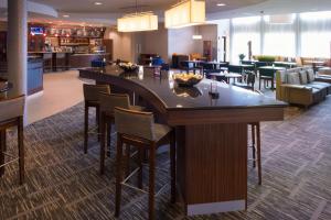 a large bar in a hotel lobby with chairs at Courtyard by Marriott Canton in North Canton