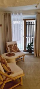 a living room with a couch and a window at Loveroom La Cesarine Jacuzzi privé in Mougins