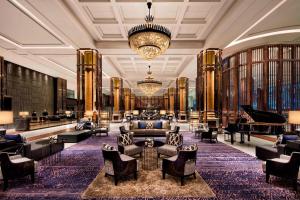 a large lobby with a grand piano and a grand room with furniture at Bangkok Marriott Marquis Queens Park in Bangkok
