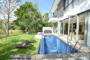 a swimming pool in the backyard of a house at Pool Villas at Danang Beach with Private Pool in Da Nang