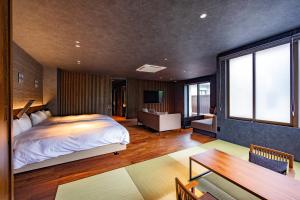 a bedroom with a bed and a living room at Urari Takeo Garden Terrace Spa Resorts in Takeo