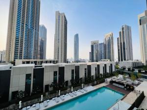 a pool in the middle of a city with tall buildings at ROYAL APARTMENTS DUBAI in Dubai