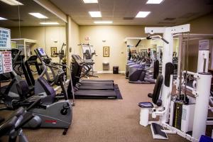 a gym with treadmills and machines in a room at Ocean Landings Resort in Cocoa Beach