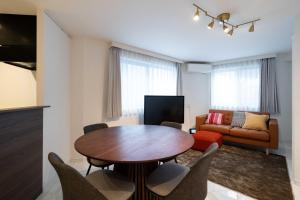 a living room with a table and a couch at Bonheur Akasaka in Tokyo