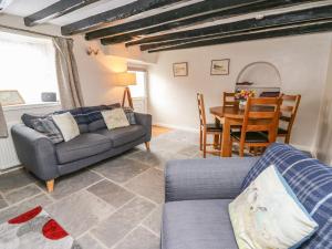 a living room with a couch and a table at Eiddwen in Llanon