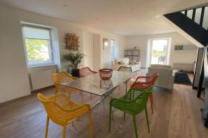 a living room with a table and chairs at Maison bretonne - cottage in Lézardrieux