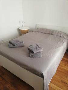 a bed with two towels on top of it at Charming 2 bedrooms flat near Trocadéro in Paris