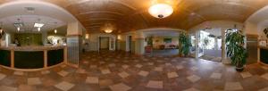 a large room with a lobby with a large ceiling at Rocklin Park Hotel in Rocklin