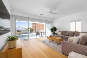 a living room with a couch and a table at HideAwayII at Shoal Bay in Shoal Bay