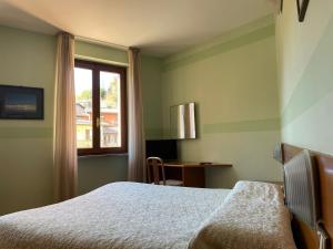 Ένα ή περισσότερα κρεβάτια σε δωμάτιο στο Hotel Ristorante Centrale