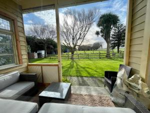 a screened in porch with a view of a field at Big Fully Equipped 3BRM Quiet Farm House Near Beach & 12 min to Town in Riverton