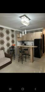 a kitchen and dining room with a table and chairs at Orbi Sea Towers in Batumi