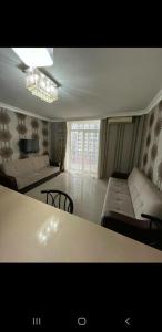 a living room with a couch and a table at Orbi Sea Towers in Batumi