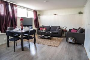 a living room with a table and a couch at Bnb Central Apartment Stavanger nicolas 4 in Stavanger