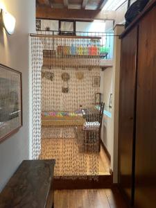 a room with a wooden floor and a wall with a cage at Wedding and Family House in Malcesine