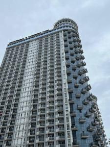 a tall building with balconies on the side of it at Orbi Sea Towers in Batumi