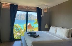 una camera da letto con un letto con una grande finestra di HIP Seaview Resort @ Phi Phi a Phi Phi Don