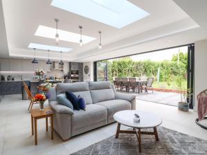 a living room with a couch and a table at Kite View Cottage in High Wycombe