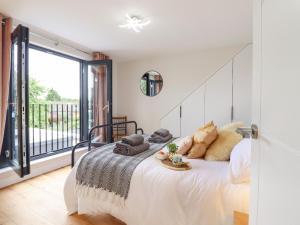 a bedroom with a large bed and a large window at Kite View Cottage in High Wycombe