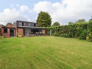 a house with a lawn in front of it at Kite View Cottage in High Wycombe