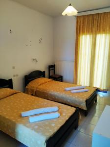 una camera d'albergo con due letti e asciugamani di Royal Club Hotel - Aqua Poolside Bliss a Kamenitsotaíika