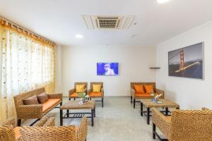 a waiting room with chairs and tables at Hotel Ambrosiana in Misano Adriatico