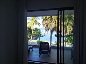 a room with a window with a view of the ocean at CAPLAGE -Beach Front Luxury Apartment at Searock in Tamarin