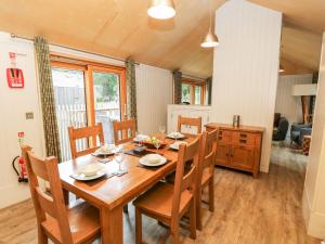 a dining room with a wooden table and chairs at Lodge 6 in Wareham