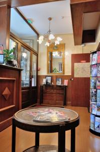 a room with a table and a mirror at Hôtel Verlaine in Paris