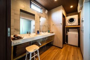 a bathroom with a sink and a microwave at Private Villa ietona in Fujikawaguchiko