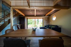 a dining room with a wooden table and chairs at Private Villa ietona in Fujikawaguchiko