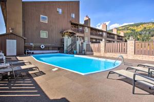 a large swimming pool with chairs and a building at The Copperado at Copper Valley in Copper Mountain