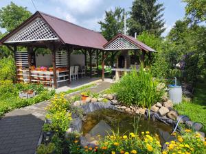 a garden with a pond and a gazebo at La mama Marta in Sovata