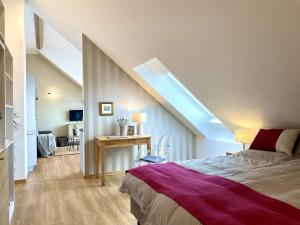 a attic bedroom with a bed and a skylight at Ferienwohnung Fernblick in Königsberg in Bayern