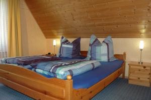 a bedroom with a large wooden bed with pillows at Ruegen_Fewo 69 in Ummanz