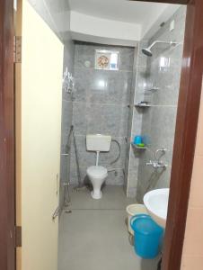 a small bathroom with a toilet and a sink at Yangzom Homez in Siliguri